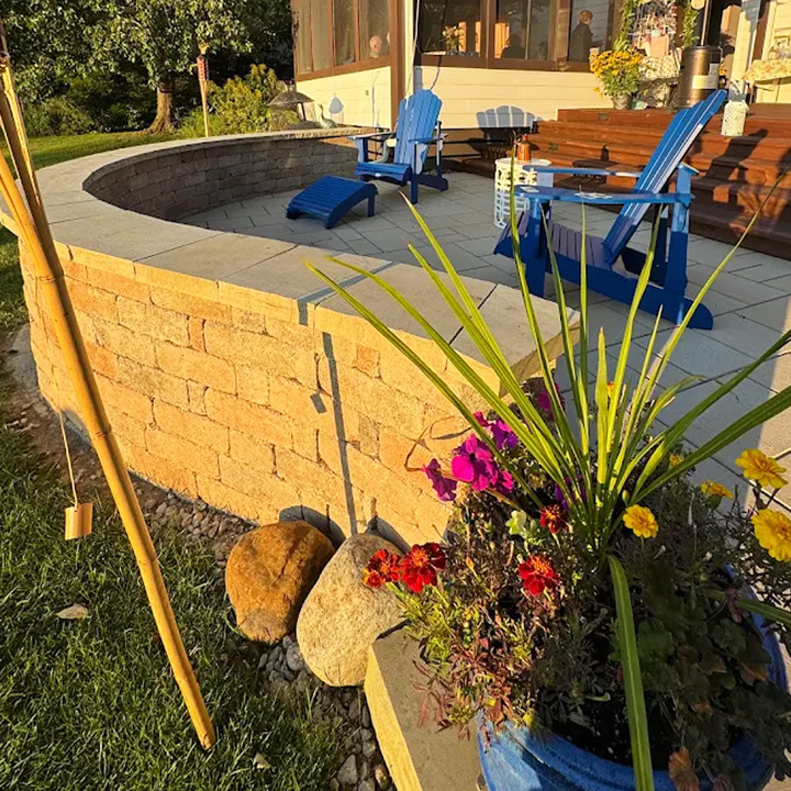 Curved stone sitting wall and patio in evening light